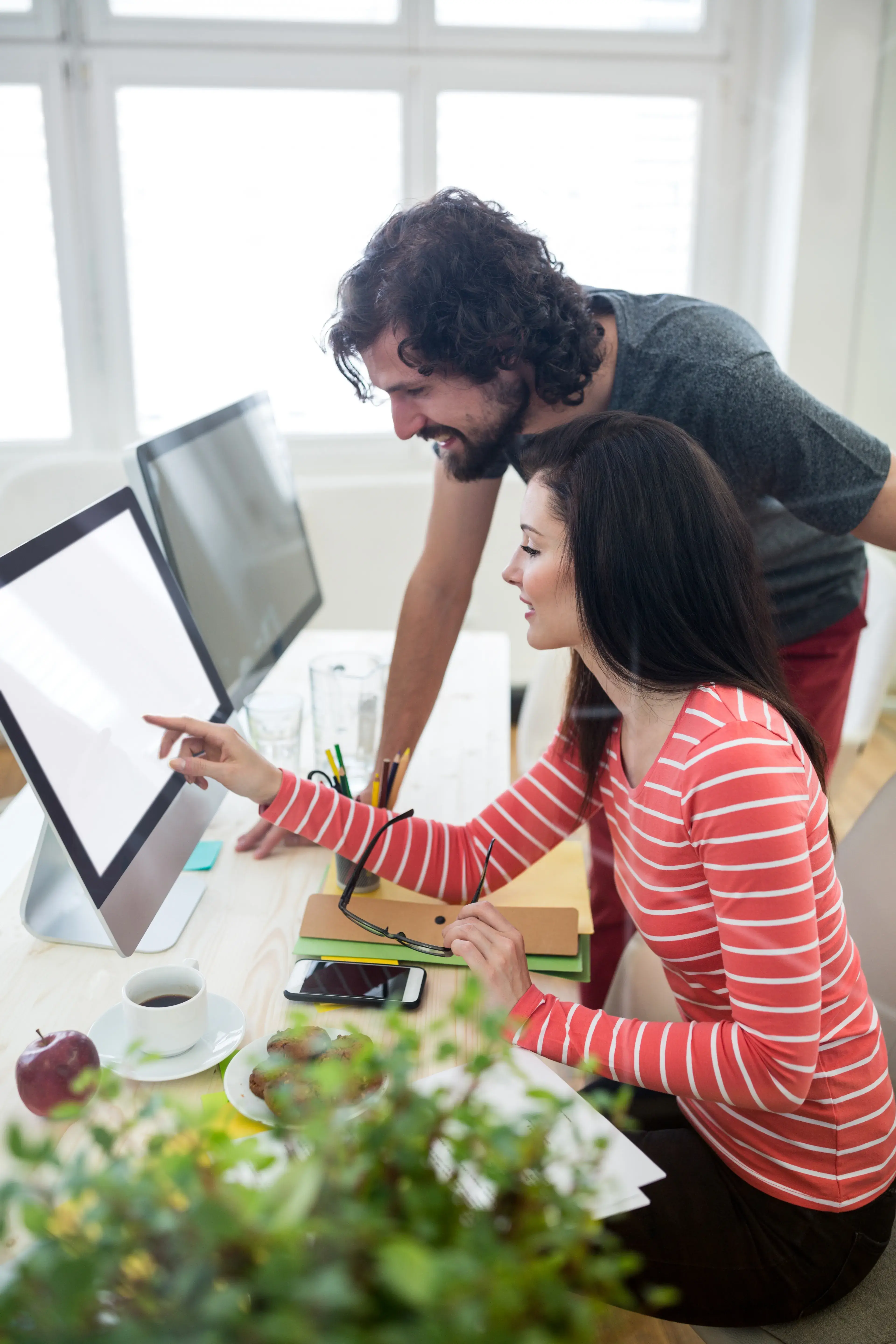 male-female-graphic-designers-interacting-computer